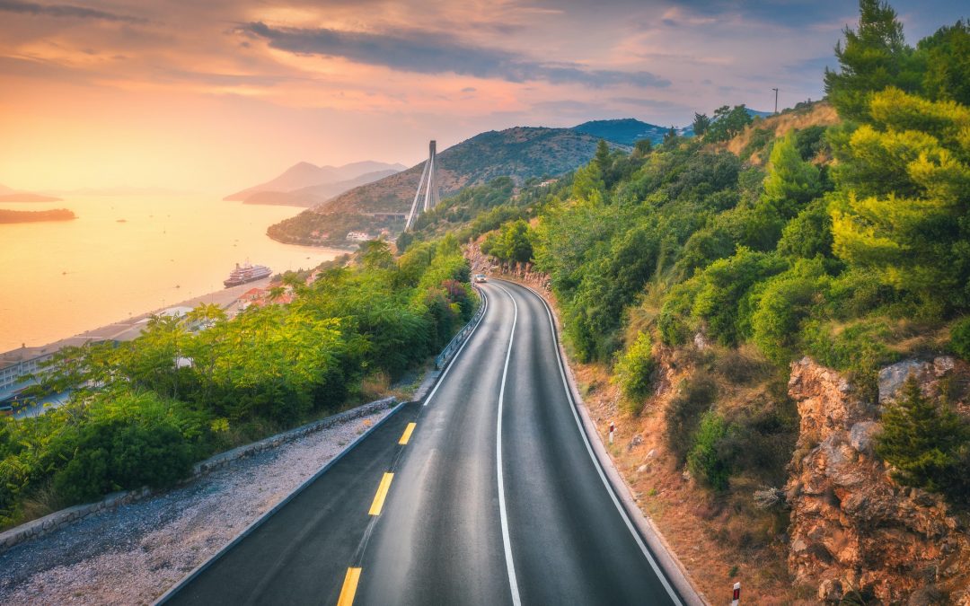 Aerial view of perfect mountain road and beautiful green forest